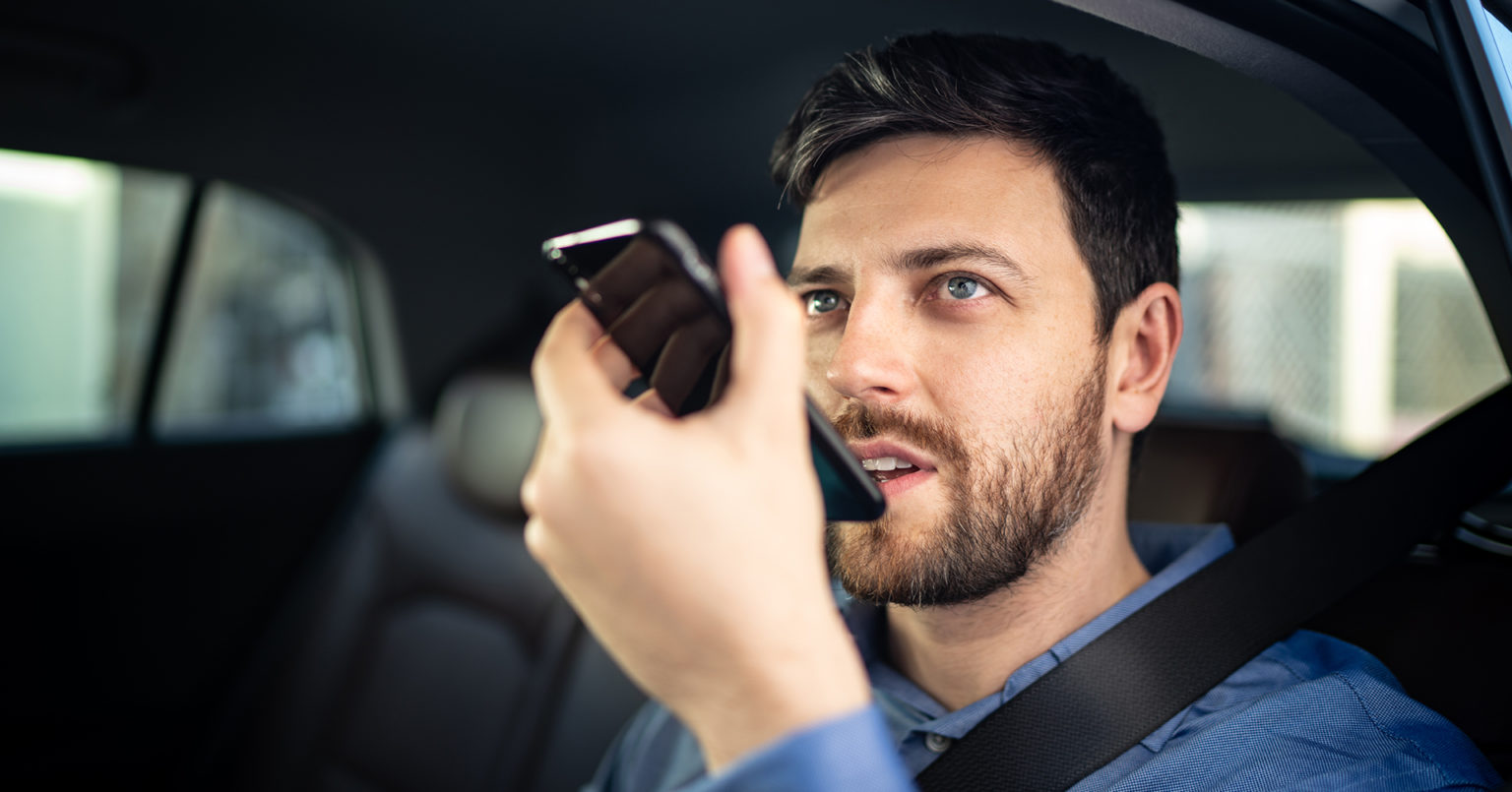 A person using voice assistant application on his mobile phone.